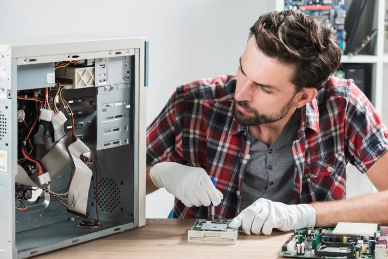 male-technician-working-broken-computer