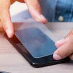 The,Man,Replacing,The,Broken,Tempered,Glass,Screen,Protector,For